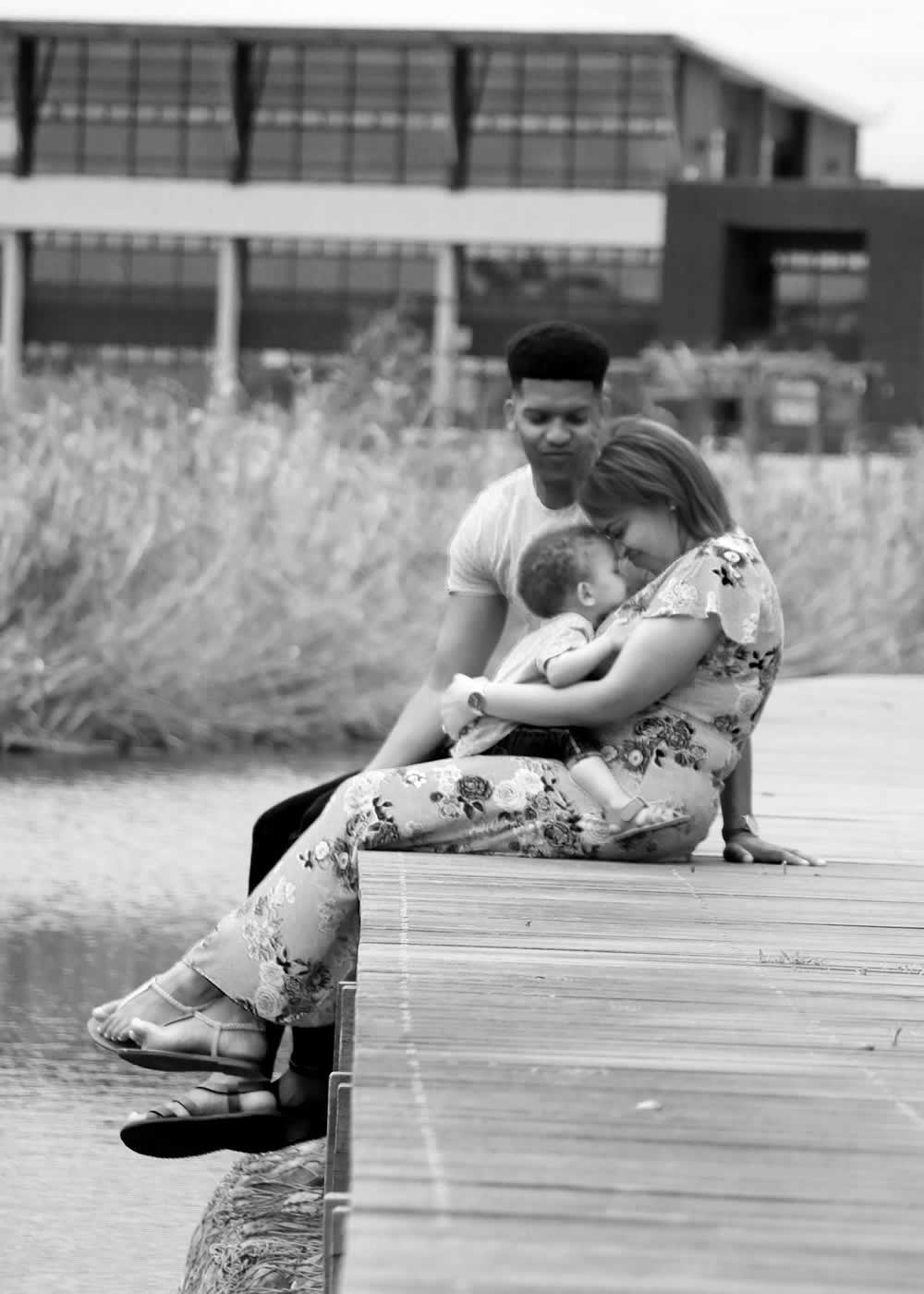 noah fam (54) Lifestyle Portraits - family seated on dock with baby on mom's lap